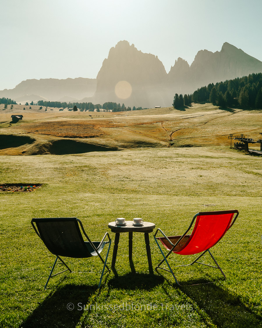 Golden hour light over Alpe di Siusi alpine meadow with Sassolungo mountain peaks in the background, Dolomites, South Tyrol, Italy