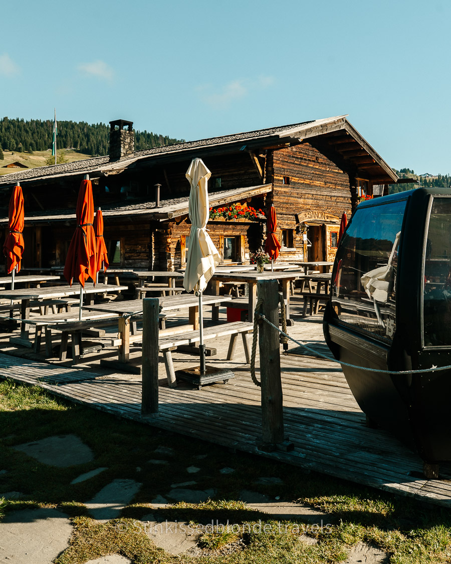 Traditional alpine h&uuml;tte on the Seiser Alm plateau surrounded by summer meadows and Dolomite mountain scenery, South Tyrol, Italy