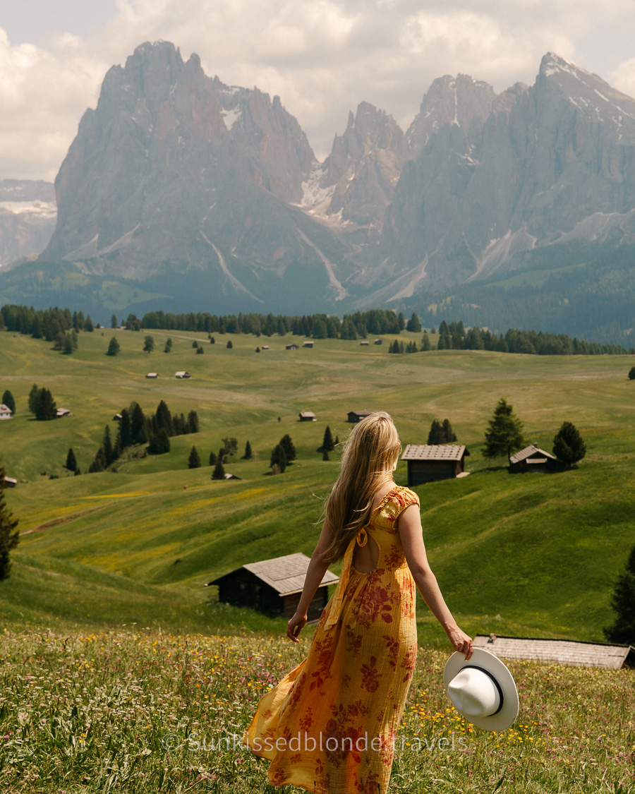 Golden hour light over Alpe di Siusi alpine meadow with Sassolungo mountain peaks in the background, Dolomites, South Tyrol, Italy