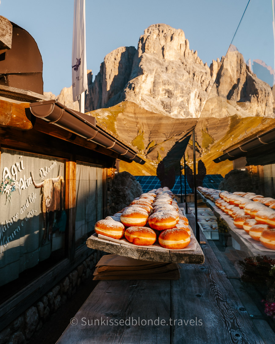 Rifugio Friedrich August for the Famous Doughnuts at Golden hour light over Alpe di Siusi alpine meadow with Sassolungo mountain peaks in the background, Dolomites, South Tyrol, Italy