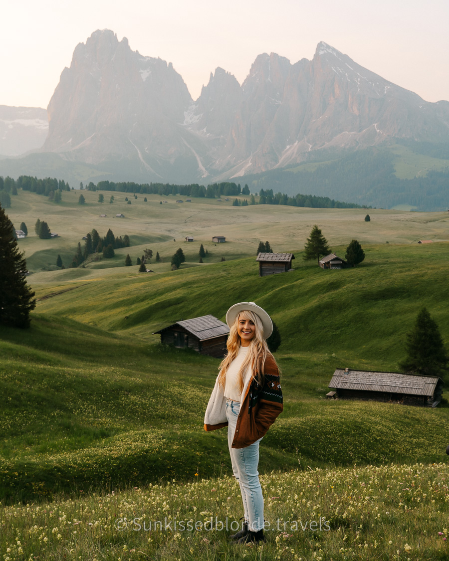 Golden hour light over Alpe di Siusi alpine meadow with Sassolungo mountain peaks in the background, Dolomites, South Tyrol, Italy