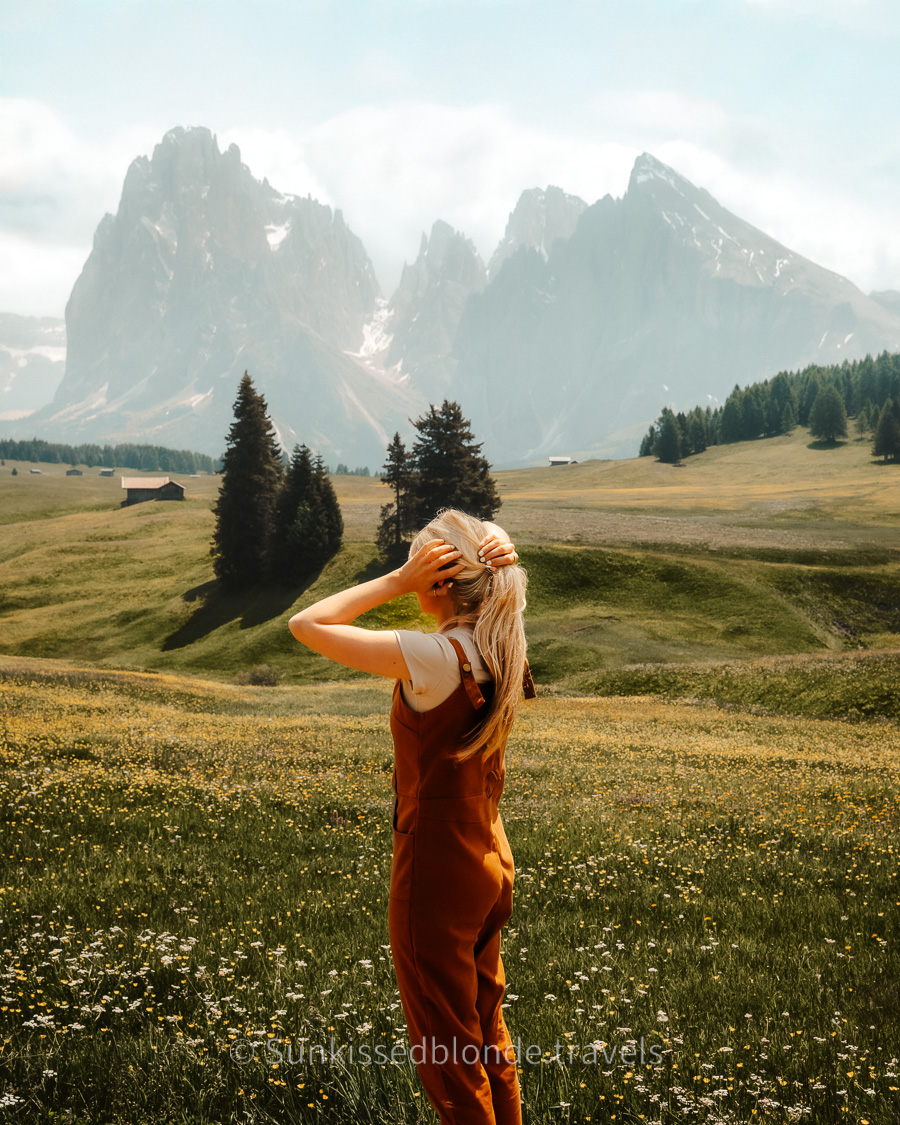 Golden hour light over Alpe di Siusi alpine meadow with Sassolungo mountain peaks in the background, Dolomites, South Tyrol, Italy